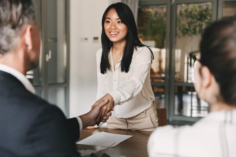 Woman shaking hands with man for job offer