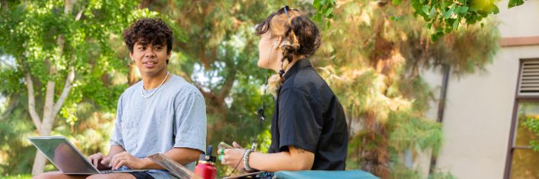 Two students sitting outside